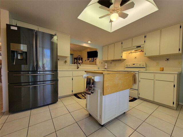 kitchen with under cabinet range hood, light countertops, fridge with ice dispenser, light tile patterned flooring, and white electric range