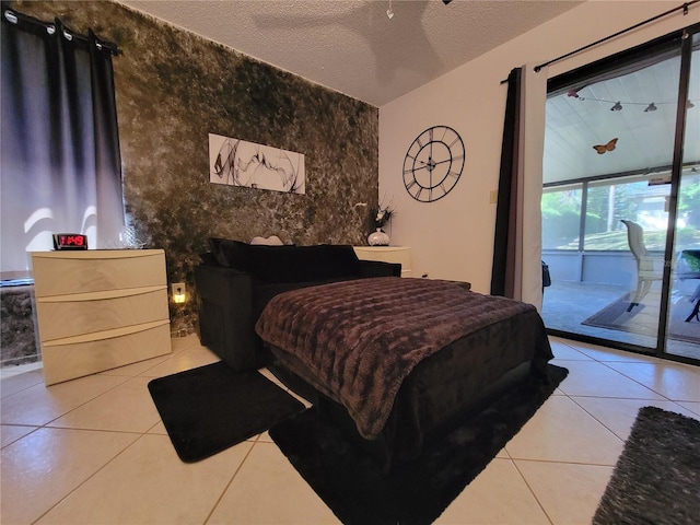 tiled bedroom with a textured ceiling and access to outside