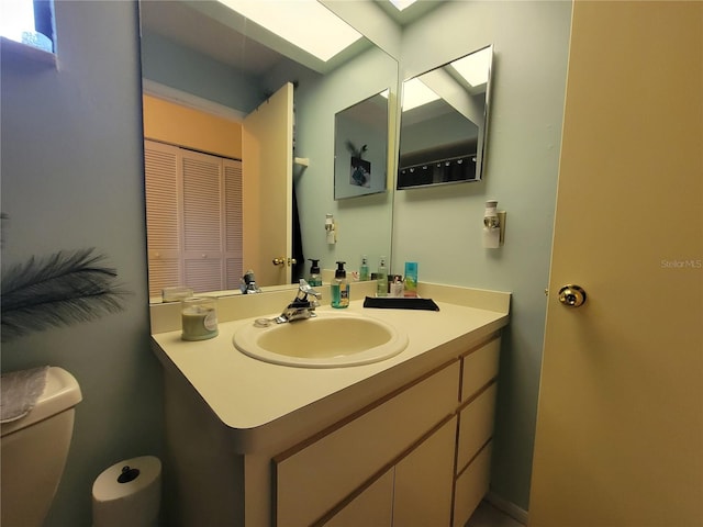 bathroom featuring toilet and vanity