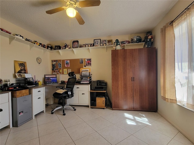 home office with light tile patterned flooring, a wealth of natural light, and a textured ceiling