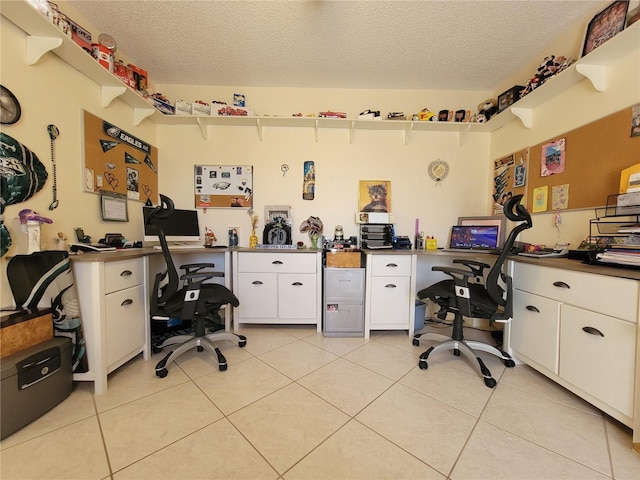 home office with light tile patterned floors and a textured ceiling