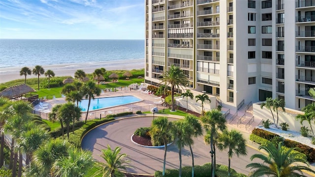 pool with a water view and a view of the beach