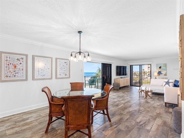 dining area with baseboards, a textured ceiling, an inviting chandelier, and crown molding