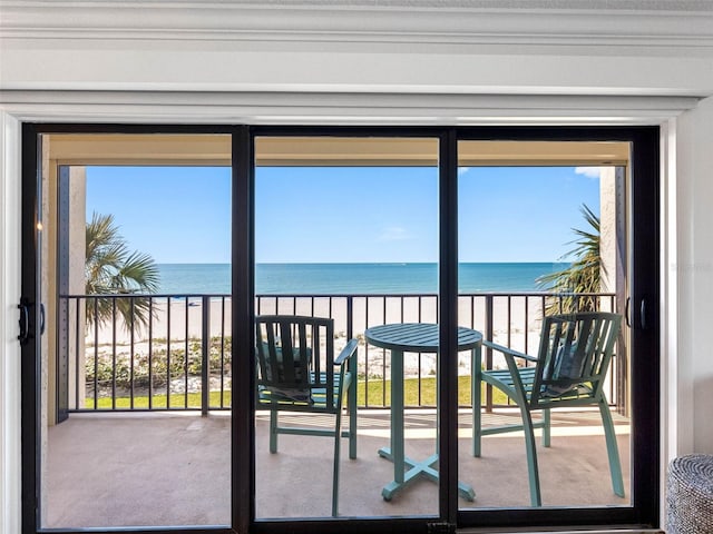 doorway to outside featuring a view of the beach and a water view