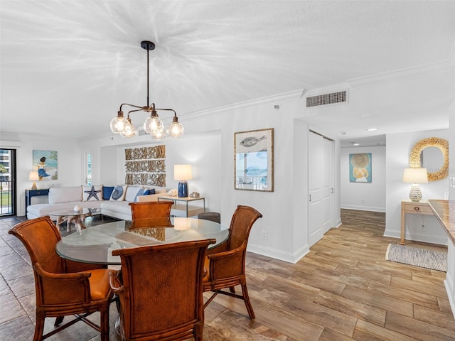 dining space with crown molding, wood finished floors, visible vents, and baseboards