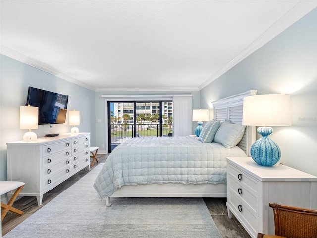 bedroom with dark wood-style floors, ornamental molding, and access to outside