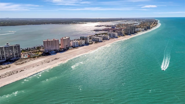 bird's eye view featuring a city view, a view of the beach, and a water view