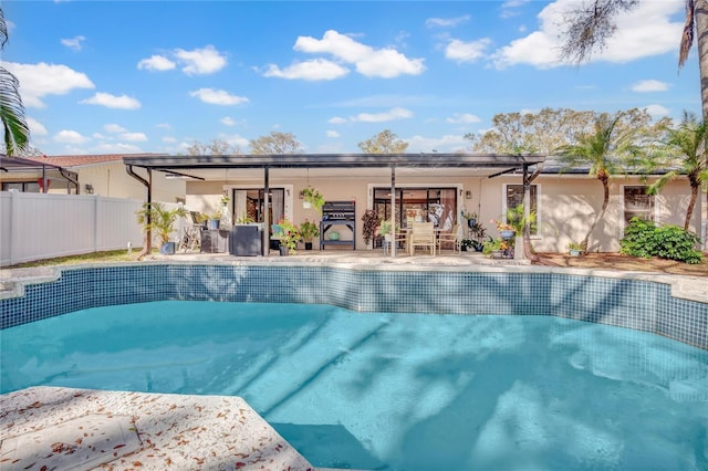 view of swimming pool featuring a patio area, fence, and a fenced in pool