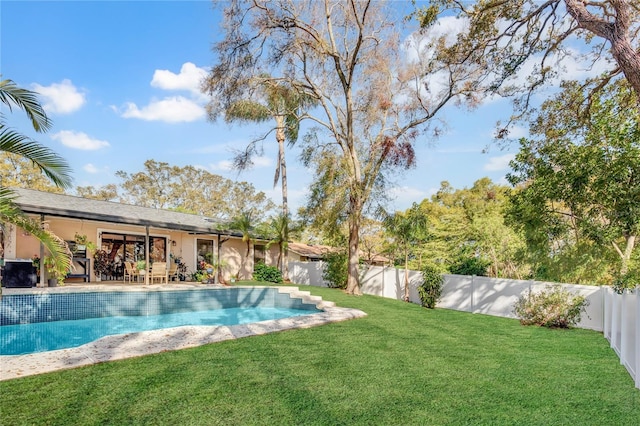 view of swimming pool with a patio area, a yard, a fenced backyard, and a fenced in pool