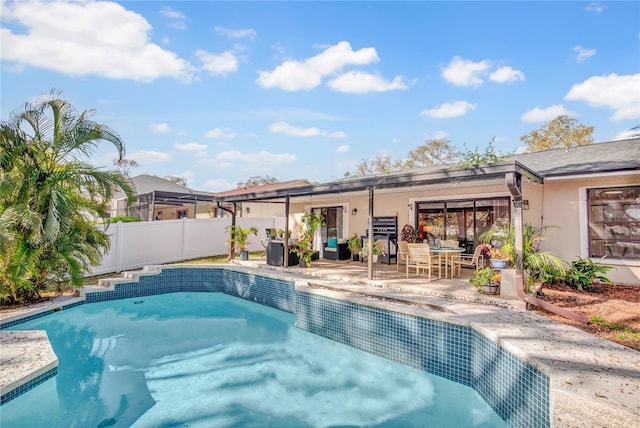 view of swimming pool with a fenced in pool, fence, and a patio area