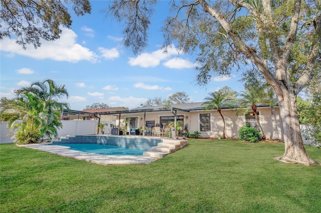 back of property featuring fence private yard, a lawn, a fenced in pool, and stucco siding