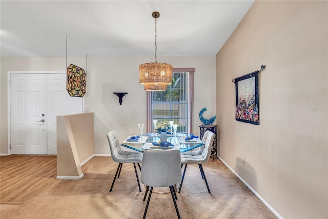 dining room with carpet flooring and baseboards