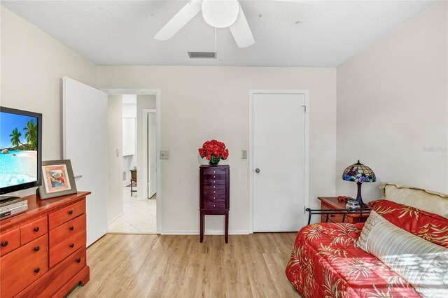 bedroom with a ceiling fan, light wood-style floors, and visible vents