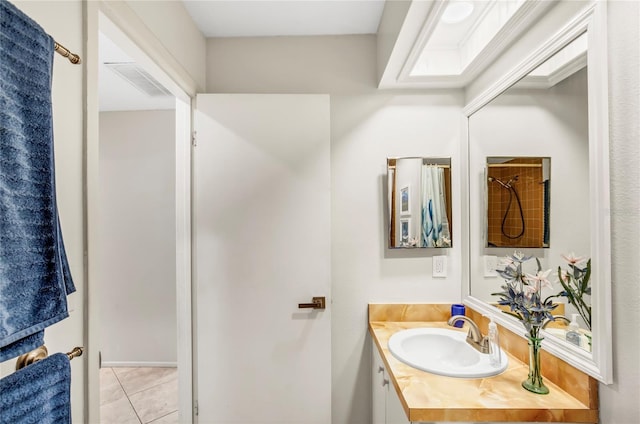 bathroom featuring tile patterned flooring, visible vents, and vanity