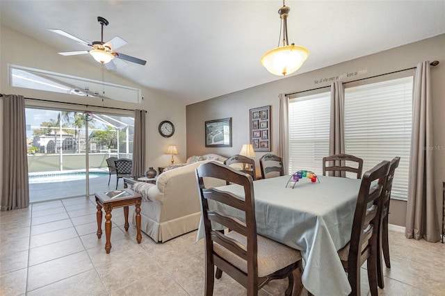 dining area featuring lofted ceiling, light tile patterned floors, and a ceiling fan