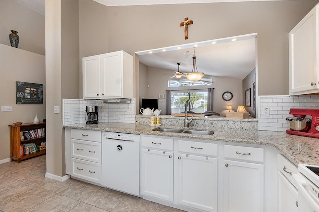 kitchen with white dishwasher, a sink, stove, vaulted ceiling, and white cabinetry