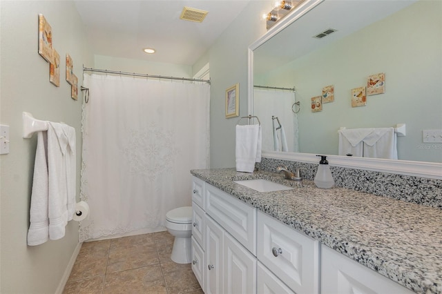 bathroom with tile patterned flooring, visible vents, toilet, and vanity