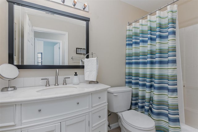 bathroom featuring curtained shower, toilet, and vanity