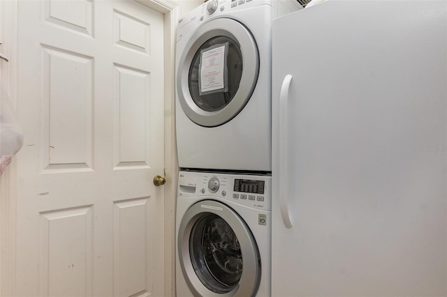 laundry area with stacked washer and dryer