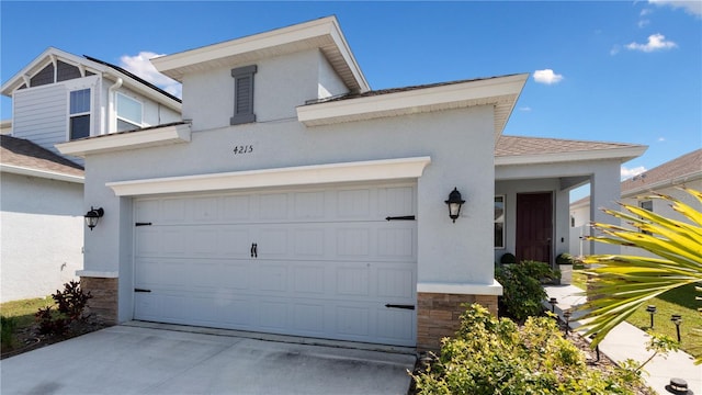 view of front of home featuring stone siding, stucco siding, driveway, and a garage