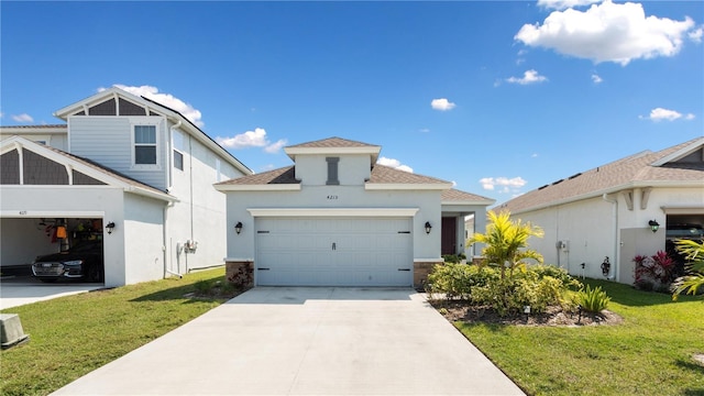 view of front facade with driveway, a front yard, and a garage