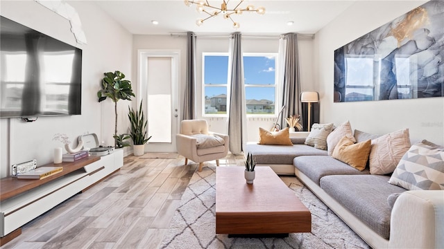 living room with a chandelier and wood finished floors