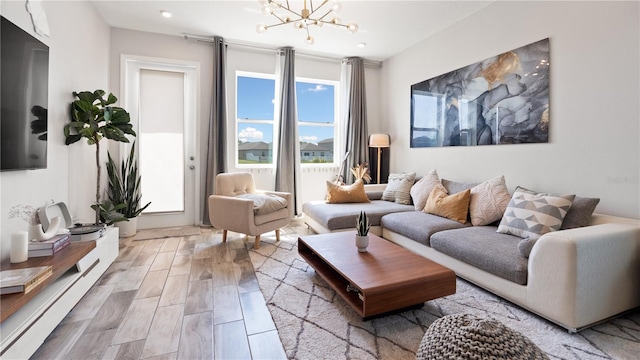 living area with an inviting chandelier and wood finished floors