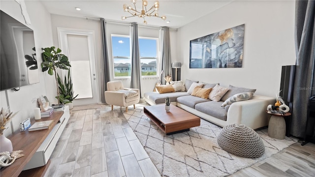 living area featuring a notable chandelier and wood finished floors