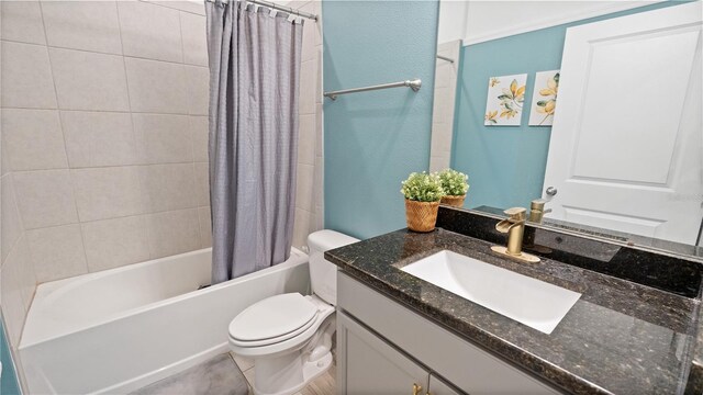 bathroom with vanity, shower / tub combo, and toilet