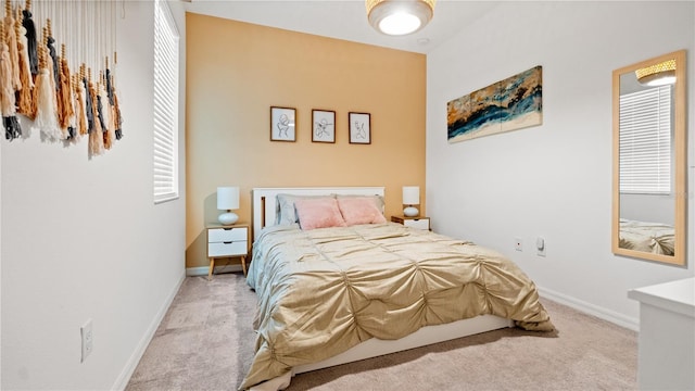 carpeted bedroom featuring baseboards