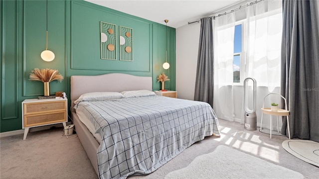 bedroom featuring light colored carpet and baseboards