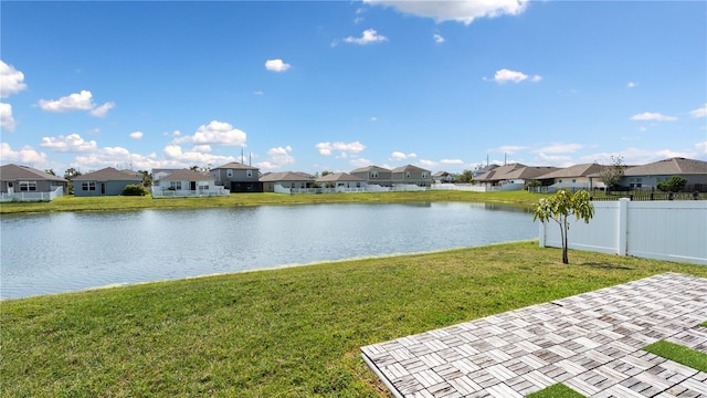 view of water feature with a residential view and fence