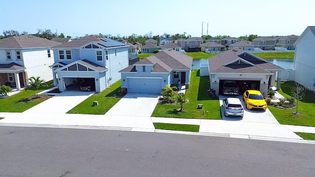 view of front of home featuring a front yard, a residential view, and driveway