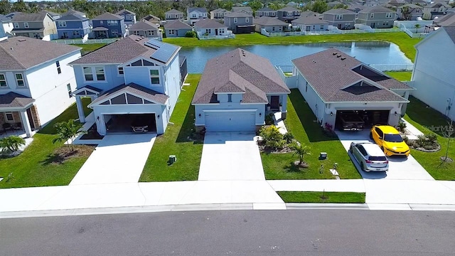 bird's eye view featuring a residential view and a water view