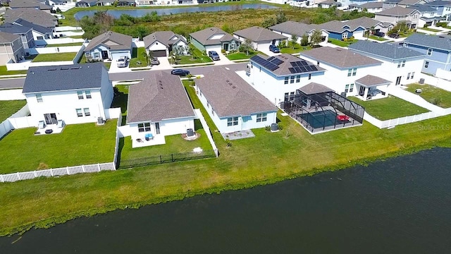 drone / aerial view featuring a residential view and a water view