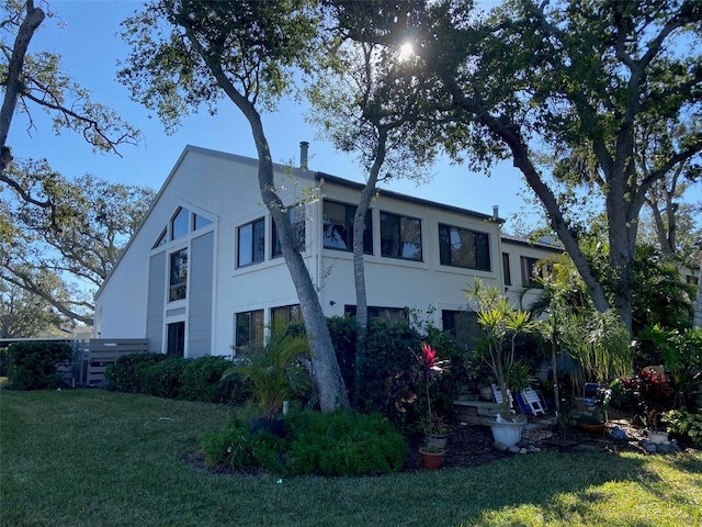 view of property exterior featuring a yard and stucco siding