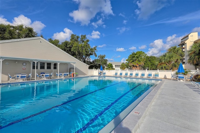 community pool featuring a patio area and fence