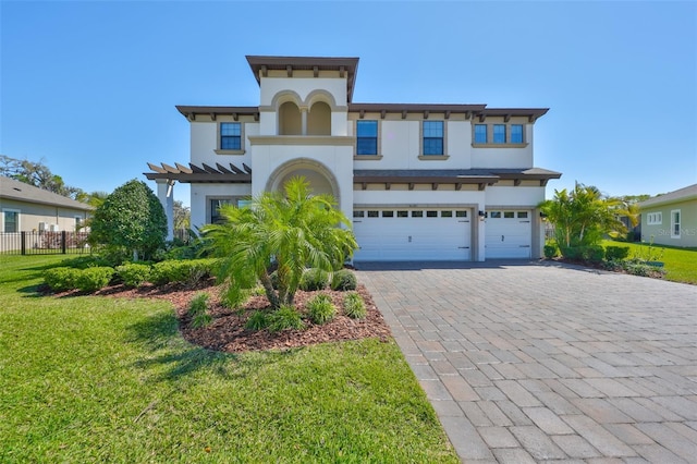 view of front facade with stucco siding, decorative driveway, a garage, and fence