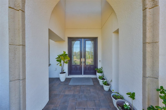 entrance to property with stucco siding and french doors