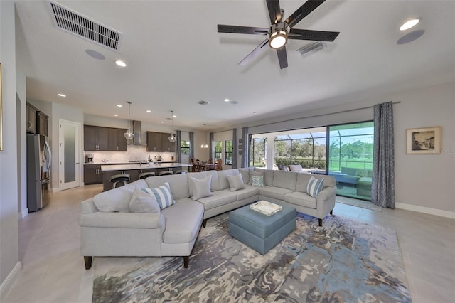 living area with recessed lighting, visible vents, baseboards, and light tile patterned floors