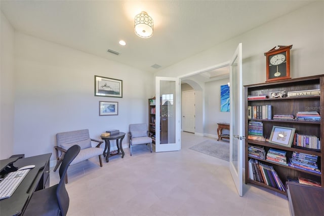 office area with baseboards, french doors, arched walkways, and visible vents