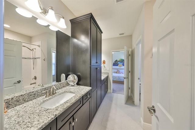 full bath featuring visible vents, shower / bathtub combination, ensuite bathroom, tile patterned floors, and vanity