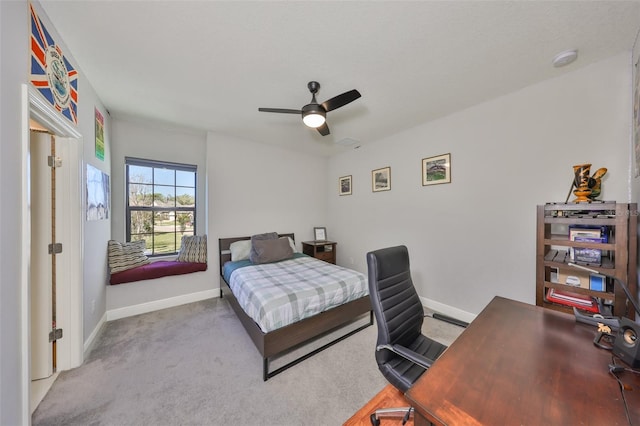 carpeted bedroom featuring a ceiling fan and baseboards