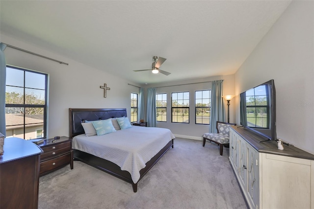 bedroom featuring baseboards, light carpet, and ceiling fan