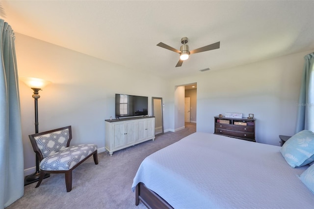 carpeted bedroom featuring baseboards, visible vents, and ceiling fan