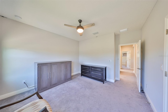 unfurnished bedroom with light colored carpet, visible vents, baseboards, and ceiling fan