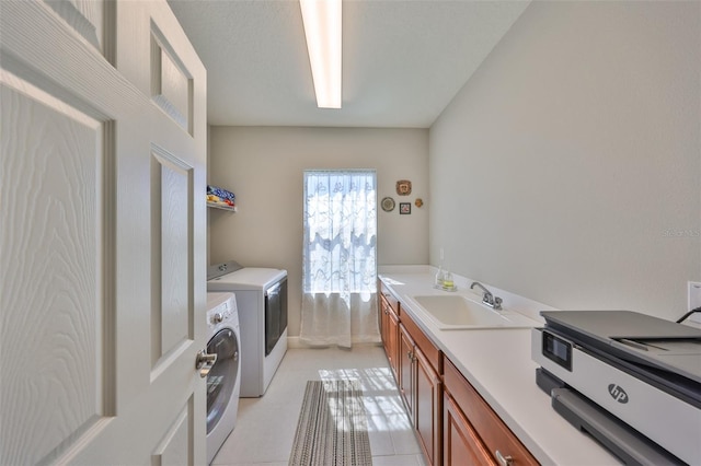 laundry area featuring a sink, separate washer and dryer, and laundry area