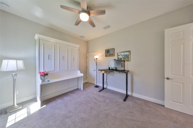 interior space featuring ceiling fan, baseboards, and light carpet