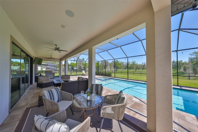 exterior space with an outdoor living space, glass enclosure, an outdoor pool, and a ceiling fan