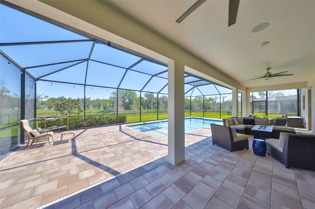 view of patio / terrace with an outdoor pool, glass enclosure, an outdoor hangout area, and ceiling fan